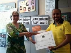 CSUEB American Language Program student Mohammed Alanazi (right) receives prize for Esther Briano Essay Award from Barbara Forsberg, ALP assistant director.